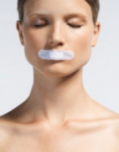 Woman with Bandage Over Mouth --- Image by © Joerg Steffens/zefa/Corbis